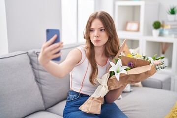 Poster - Caucasian woman holding bouquet of white flowers taking a selfie picture depressed and worry for distress, crying angry and afraid. sad expression.