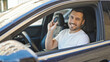 © Krakenimages.com - Young hispanic man smiling confident holding key of new car at street