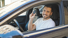 Young Hispanic Man Smiling Confident Holding Key Of New Car At Street