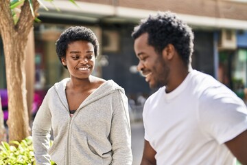 Sticker - African american man and woman couple speaking together at street