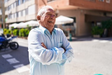 Poster - Middle age grey-haired man standing with arms crossed gesture at street