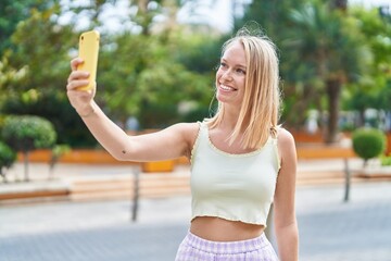 Sticker - Young blonde woman smiling confident making selfie by the smartphone at park