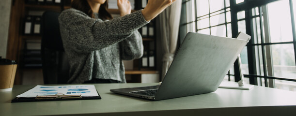 Creative Asian young woman working on laptop in her studio