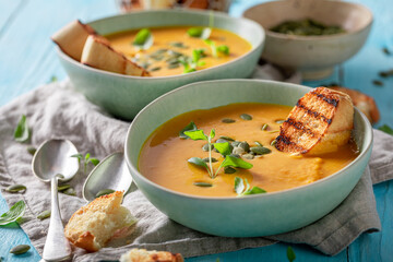 Wall Mural - Creamy pumpkin soup with crostini and pumpkin seeds.