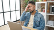 © Krakenimages.com - Young latin man stressed using laptop sitting on table at dinning room