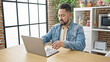 © Krakenimages.com - Young latin man using laptop sitting on table at dinning room