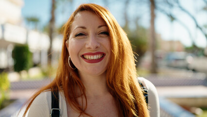 Wall Mural - Young redhead woman smiling confident standing at park