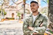 © Krakenimages.com - Young hispanic man smiling confident standing with arms crossed gesture at park
