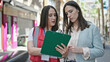 © Krakenimages.com - Two women having survey interview writing on clipboard at street