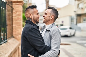 Poster - Two men couple smiling confident hugging each other at street