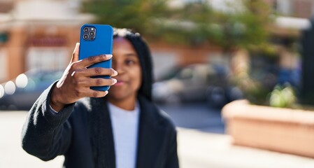 Poster - African american woman smiling confident making selfie by the smartphone at street