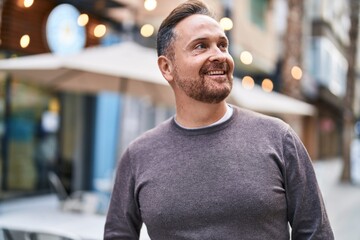 Wall Mural - Young caucasian man smiling confident looking to the side at coffee shop terrace