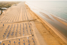Morning On The Still Deserted Beach. Umbrella Beach For Relaxing And Sun Set Beach. Bibione, Italy