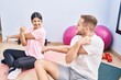 © Krakenimages.com - Man and woman couple smiling confident stretching at sport center