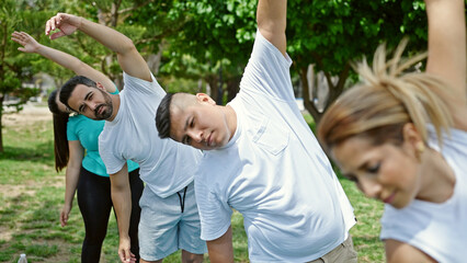 Poster - Group of people training yoga at park