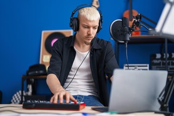 Sticker - Young caucasian man musician having dj session at music studio