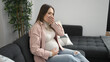 © Krakenimages.com - Young pregnant woman touching belly suffering nausea at home