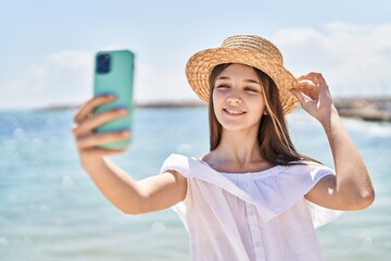 Sticker - Adorable girl tourist smiling confident make selfie by the smartphone at seaside