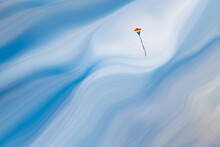 Rainbow Kite Against A Blue Cloudy Sky, And The Sky Is Streaked After The Fashion Of Photographer Josh Adamski