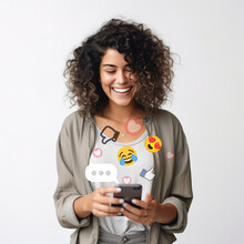 Photo Of Cheerful Delighted Woman Types Sms On Modern Cell Phone Device, Enjoys Good Internet Connection, Using Social Media, Isolated On Grey Studio Wall
