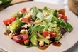 Tasty salad with balsamic vinegar in plate, closeup
