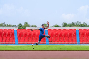 Wall Mural - Asian male athlete with prosthetics runs at full speed, demonstrating a powerful practice on stadium track