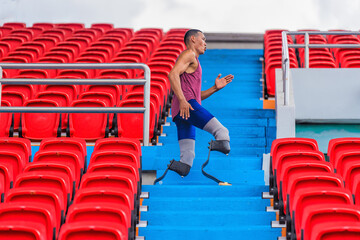 Wall Mural - Asian male athlete with prosthetics, exercises by jogging in stadium bleachers aisle