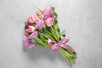 Wall Mural - Beautiful bouquet of colorful tulip flowers on light gray table, top view