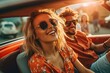 Happy young couple driving a convertible car on a city street. Summer vacation and travel concept