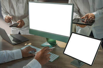 Wall Mural - young man working businessman using a desktop computer of the blank screen online advertising