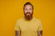 © Drobot Dean - Mid bearded man in yellow shirt smiling at camera standing isolated