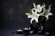 Burning candle, white lily flowers, and black funeral ribbon on a dark background with space for text