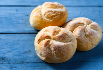 Aufkleber - Set of fresh small bun bread on a blue wooden table with copy space