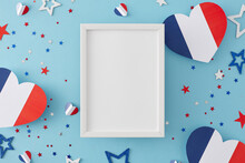 Concept Of A National Day Of France Celebration Event. Top View Flat Lay Of Patriotic Paper Hearts, Stars Confetti On Light Blue Background With Empty Frame For Ad Or Greeting
