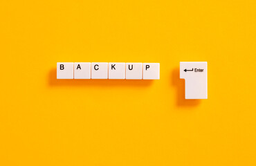 Computer file and data online backup or business backup plan concept. Computer keyboard keys with the word backup.
