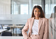 © insta_photos - Smiling elegant confident young professional business woman, female proud leader, smart businesswoman lawyer or company manager executive looking at camera standing in office, portrait.