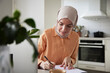 © Johnér - Smiling woman with hijab working at home