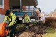 © Johnér - Male and female workers laying cables in trench
