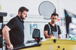 © Photocreo Bednarek - Car mechanics working to remove dent in workshop.