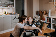 © Johnér - Mother taking care of disabled child in wheelchair at home