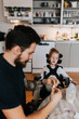 © Johnér - Disabled girl sitting at table in kitchen, father on the foreground