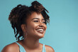 © Creative Clicks - Beautiful plus size African American woman smiling in a light blue background