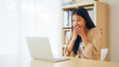 © Monster Ztudio - Funny euphoric young asian woman celebrating winning or getting ecommerce shopping offer on computer laptop. Excited happy girl winner looking at notebook celebrating success