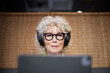 © Johnér - Senior woman with headphones using tablet