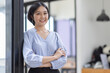 © David - Young asian woman, professional entrepreneur standing in office clothing, smiling and looking confident, workplace office background