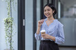 © David - Young asian woman, professional entrepreneur standing in office clothing, smiling and looking confident, workplace office background