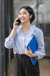 © David - Asian woman talking on a mobile phone at workplace office, Asian student girl or Business woman.