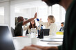 © Johnér - Group of business people high-five during business meeting in office