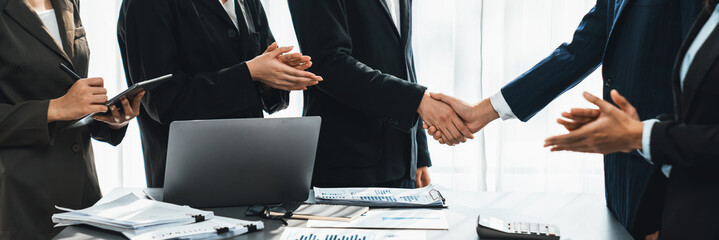 Wall Mural - Analyst team handshake after successful planning business marketing with handshake. Panorama shot group of business people handshaking after successful business negotiation in meeting room. Prodigy