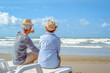 © Day Of Victory Stu. - Plan life insurance of happy retirement concepts. Senior couple sitting on chairs at the beach looking the ocean on a good day in sunny day morning.